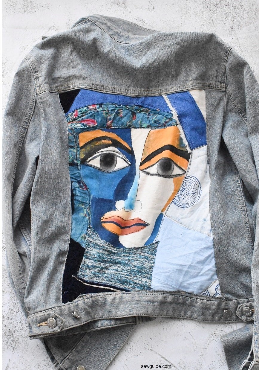 jean jacket with a painted artwork in the back