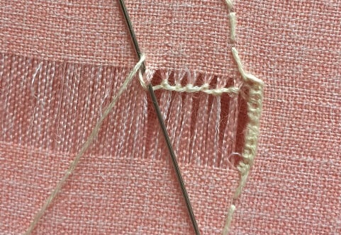 start knotting the thread on the drawn thread work