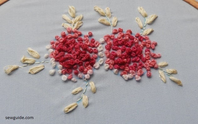 French knot stitches filling the flower designs