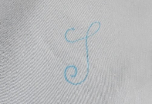 Draw the letter on the bedsheet or pillowcase