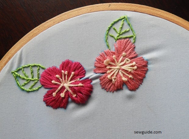 Flower designs filled with long and short stitches and the center made up of pistil stitches