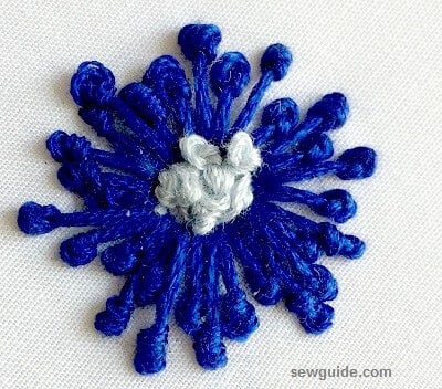 embroidered flower motifs are made with french-knot stitches in the center 