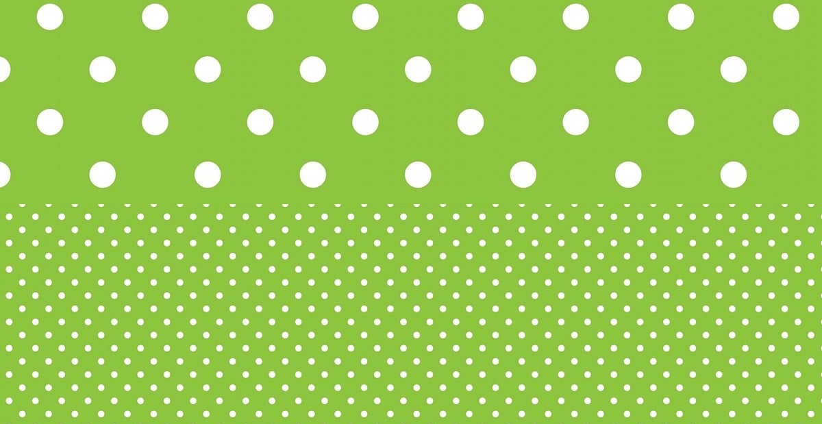 differently sized polka dots - big dots and small dots on green background