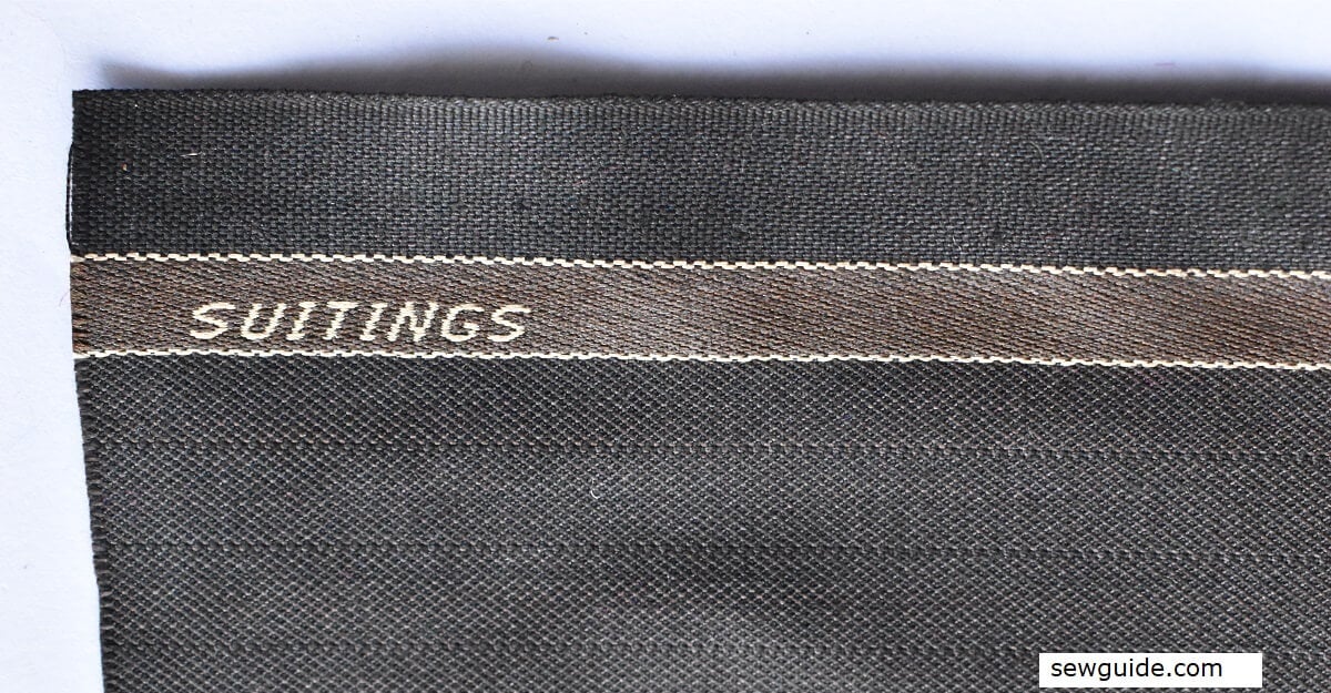 selvage of fabric with name woven into it.