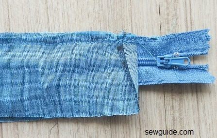 sew the facing fabric to the zipper